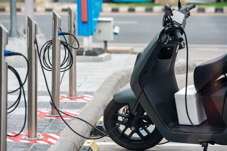Lithium-ion battery safety: e-scooter plugged into a charging station.