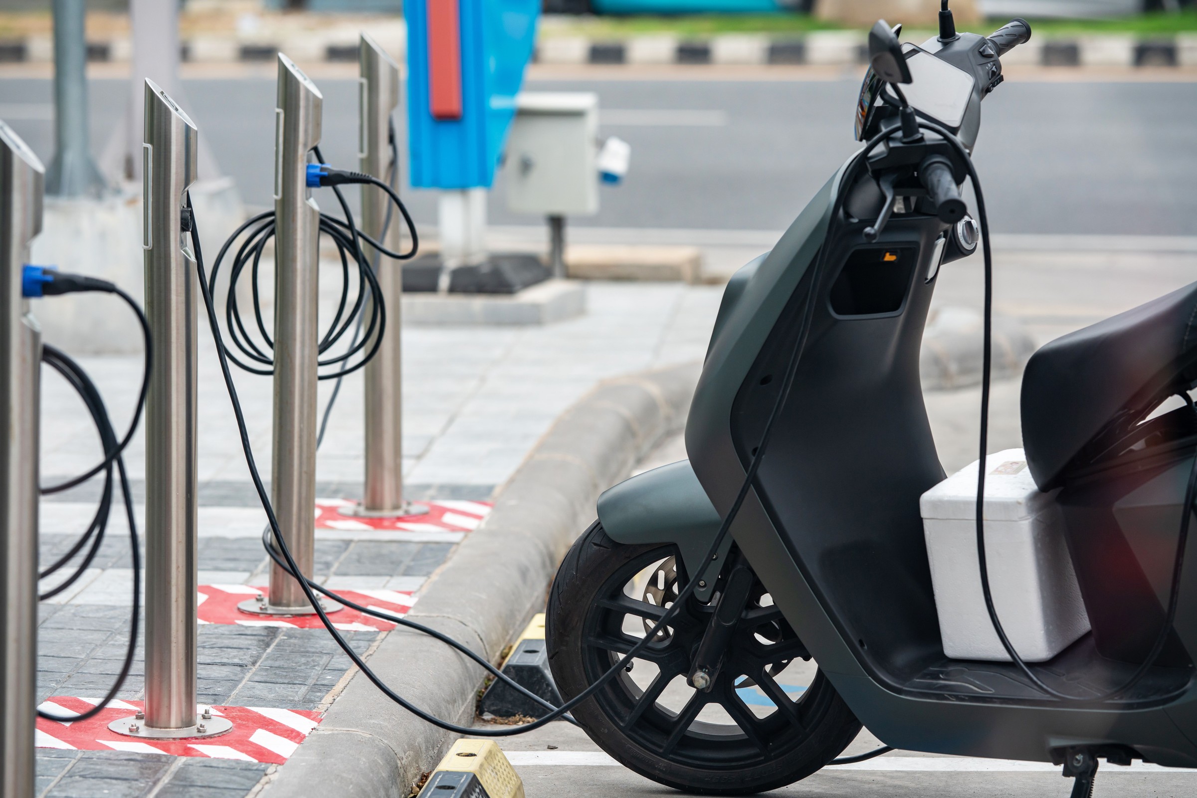 Lithium-ion battery safety: e-scooter plugged into a charging station.